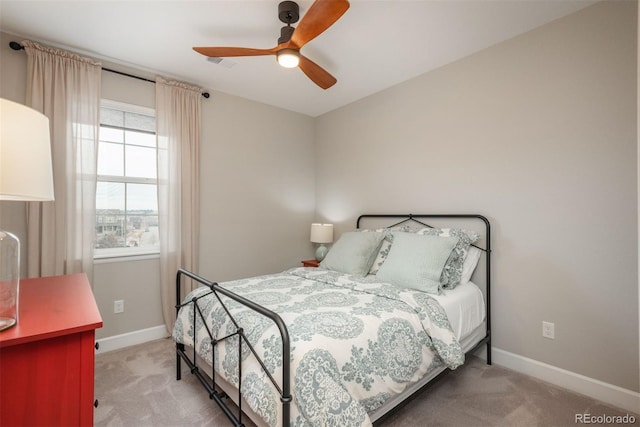 bedroom with a ceiling fan, visible vents, baseboards, and carpet flooring