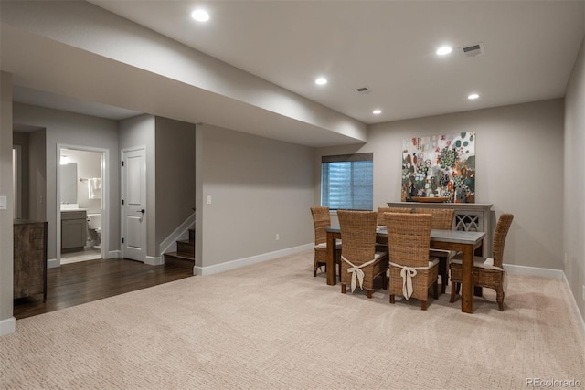 carpeted dining room featuring baseboards, stairs, visible vents, and recessed lighting