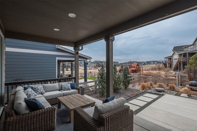 view of patio / terrace featuring a residential view, fence, and an outdoor hangout area