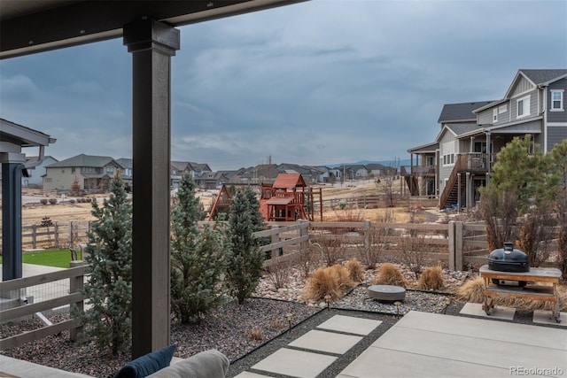 view of patio / terrace featuring a residential view and fence