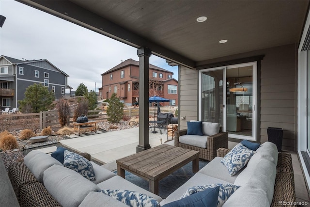 view of patio featuring outdoor lounge area and fence