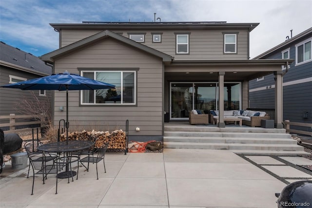 rear view of property featuring outdoor dining space, outdoor lounge area, and a patio