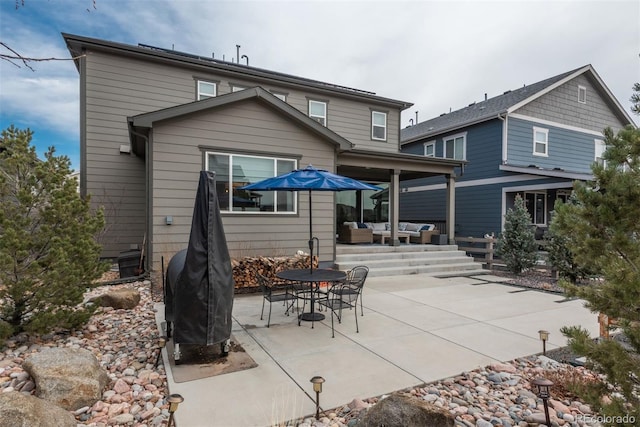 rear view of property with a patio area and an outdoor hangout area