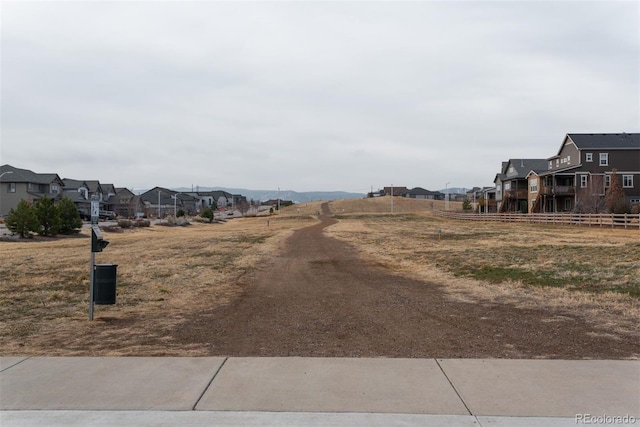 view of yard featuring fence and a residential view