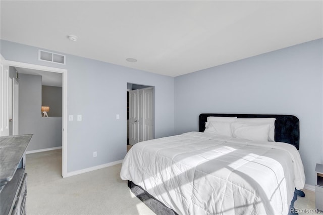 bedroom with light colored carpet, visible vents, and baseboards