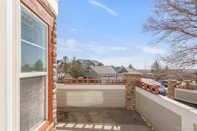 view of patio / terrace featuring a balcony and a residential view