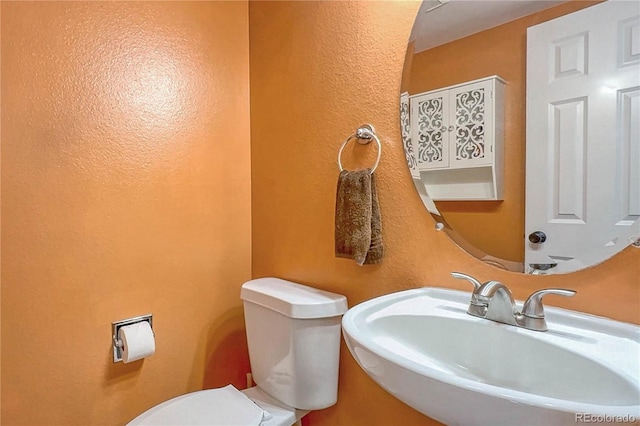 bathroom featuring sink and toilet