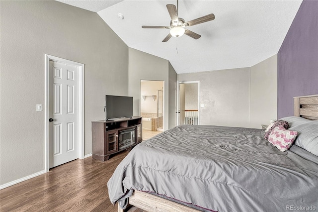 bedroom with ceiling fan, dark hardwood / wood-style floors, ensuite bathroom, and vaulted ceiling