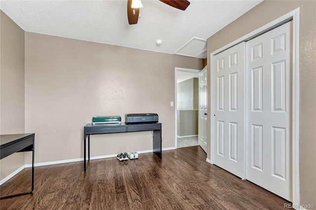 office space featuring ceiling fan, dark hardwood / wood-style flooring, and a textured ceiling