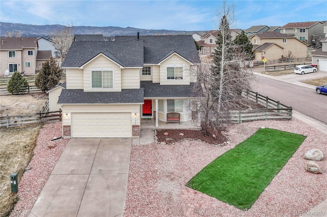 view of front of property featuring a mountain view and a garage