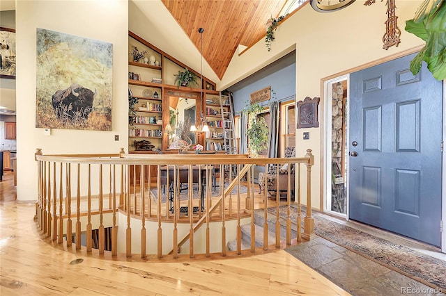 entryway with wood ceiling, high vaulted ceiling, and hardwood / wood-style floors