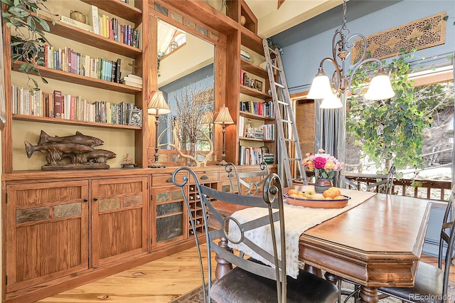 dining space featuring an inviting chandelier and light wood finished floors