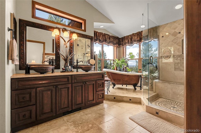 full bath with double vanity, a freestanding bath, a stall shower, a sink, and lofted ceiling