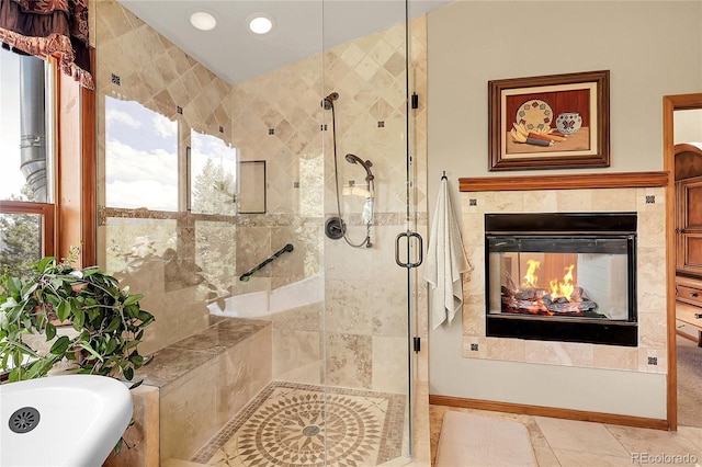 full bath featuring recessed lighting, a tiled fireplace, a bath, and a stall shower