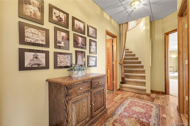 stairway featuring baseboards and wood finished floors