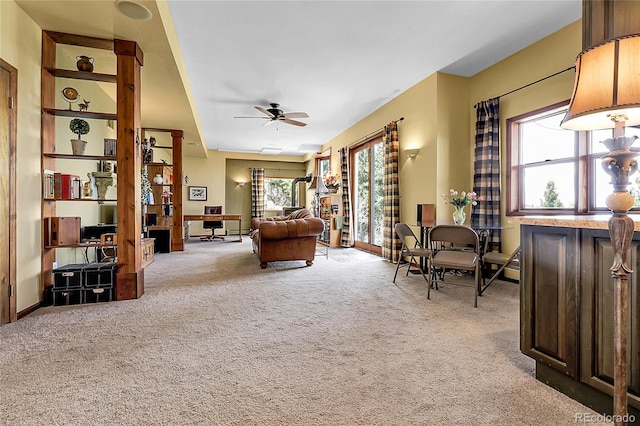 living area with carpet floors and a ceiling fan