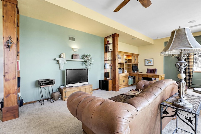 living area with carpet flooring, ceiling fan, visible vents, and baseboards