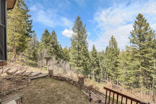 view of yard featuring a forest view