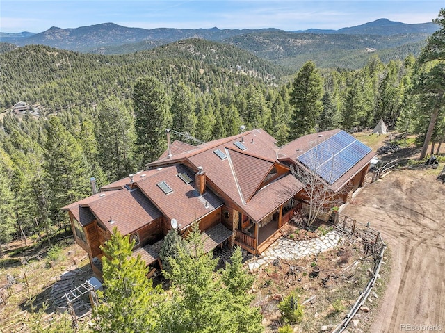 bird's eye view with a mountain view and a wooded view