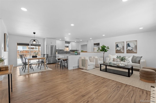 living room featuring sink and light wood-type flooring