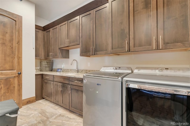 7767 Dante Dr, Littleton, CO 80125 - laundry area featuring cabinet space and independent washer and dryer