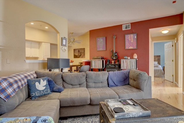 9448 E Florida Ave Unit 1078, Denver, CO 80247 - living area featuring arched walkways, ceiling fan, wood finished floors, and visible vents