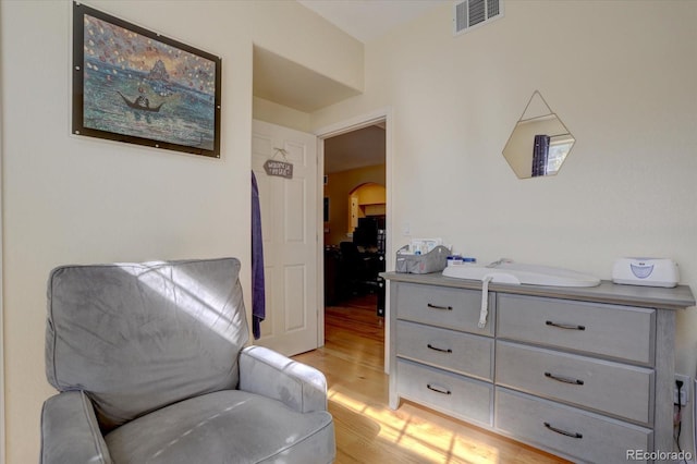 9448 E Florida Ave Unit 1078, Denver, CO 80247 - sitting room with light wood-style floors, arched walkways, and visible vents