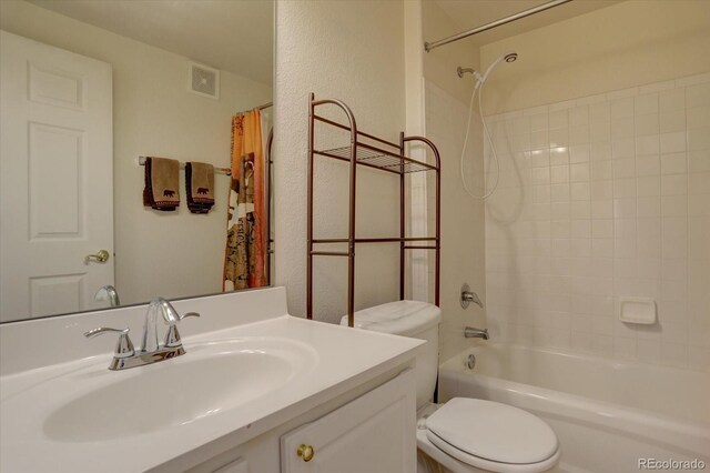 full bathroom with vanity, shower / tub combo, and toilet