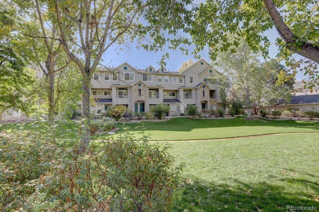 9448 E Florida Ave Unit 1078, Denver, CO 80247 - view of front of property with stone siding and a front yard