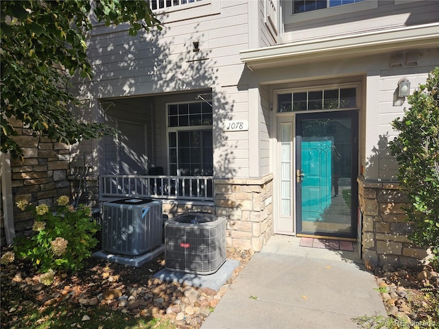 9448 E Florida Ave Unit 1078, Denver, CO 80247 - property entrance with cooling unit and stone siding