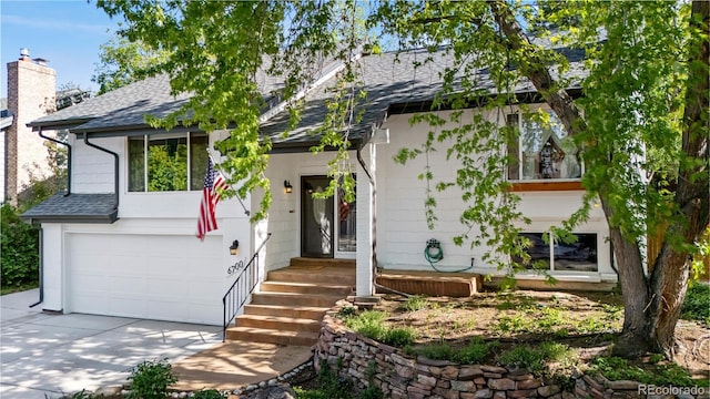 6700 W 80th Cir, Arvada, CO 80003 - view of front of property with a shingled roof, driveway, and a garage