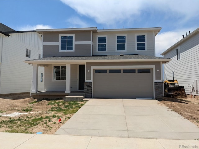992 Sandhills St, Windsor, CO 80550 - view of front of home with a porch, a garage, concrete driveway, and stone siding