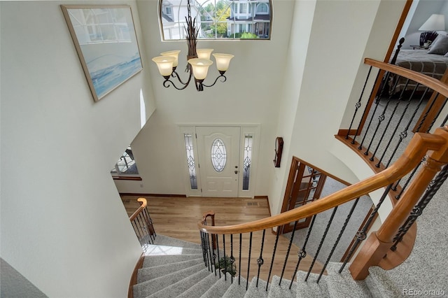 1825 Keota Ln, Superior, CO 80027 - foyer with a towering ceiling, a chandelier, wood finished floors, stairs, and baseboards