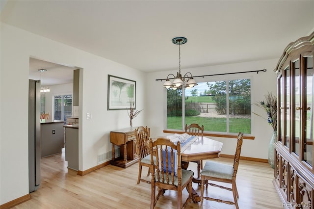 1825 Keota Ln, Superior, CO 80027 - dining room with a chandelier, light wood finished floors, and baseboards