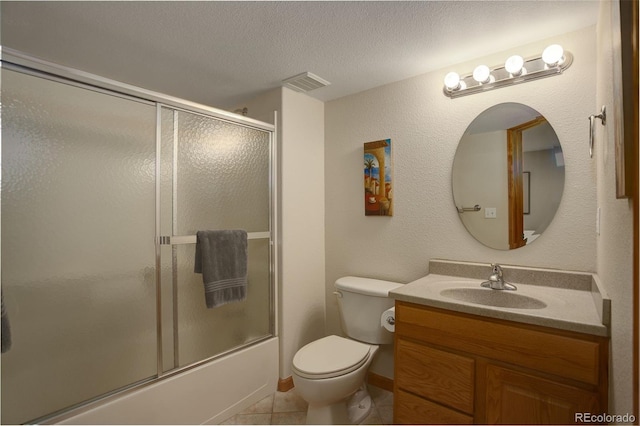 1825 Keota Ln, Superior, CO 80027 - bathroom featuring vanity, toilet, bath / shower combo with glass door, tile patterned floors, and a textured ceiling