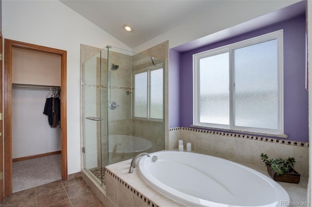 1825 Keota Ln, Superior, CO 80027 - bathroom featuring a bath, a shower stall, a walk in closet, vaulted ceiling, and tile patterned flooring