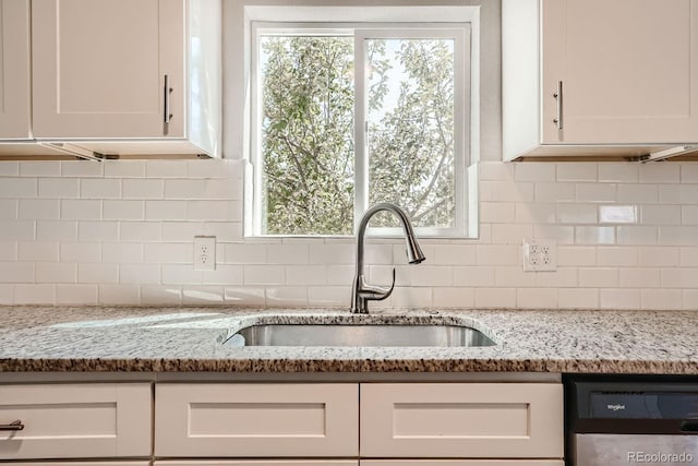4804 N Raleigh St, Denver, CO 80212 - kitchen with white cabinets, dishwashing machine, decorative backsplash, and light stone counters