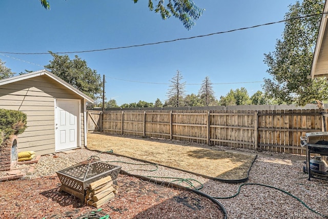 4804 N Raleigh St, Denver, CO 80212 - fenced backyard with a storage shed and an outdoor fire pit