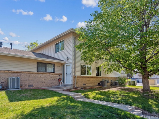 3351 S Field St Unit 150, Lakewood, CO 80227 - view of front facade with brick siding, central AC unit, and a front lawn