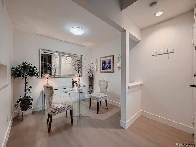 living area featuring baseboards and wood finished floors