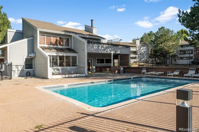 pool featuring a patio and fence