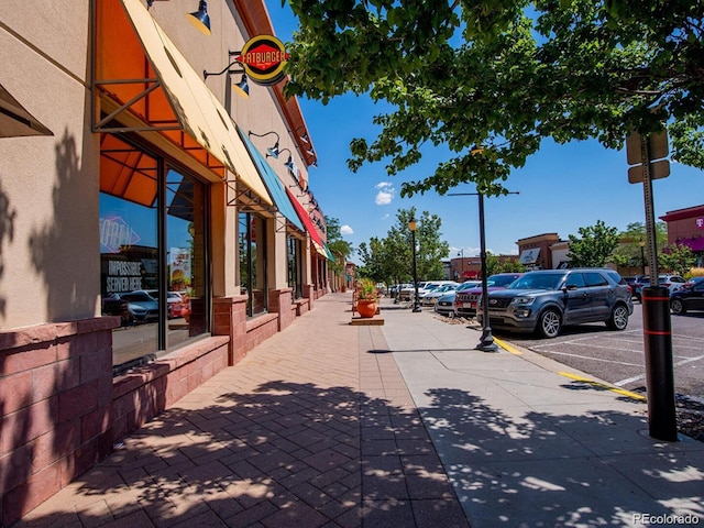 view of road featuring sidewalks, curbs, and street lighting