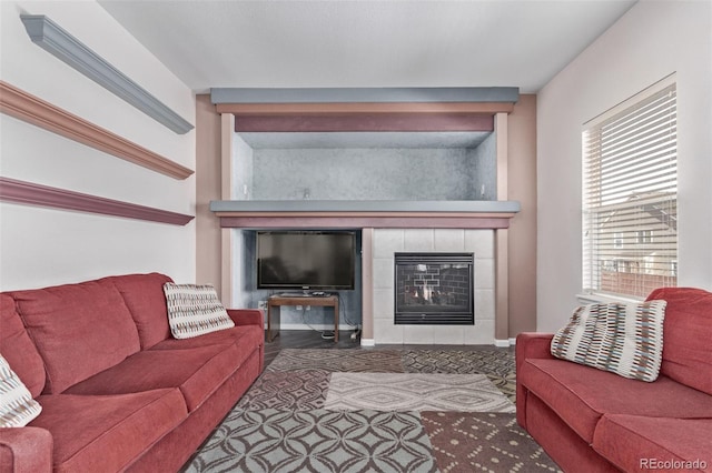 living room featuring a tile fireplace