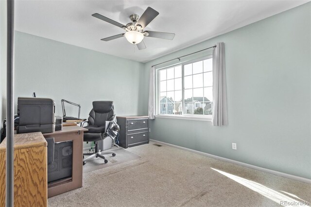 carpeted office with ceiling fan