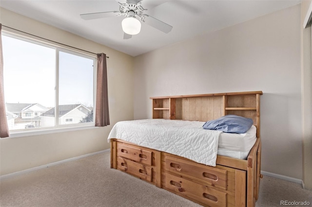 bedroom featuring ceiling fan, light colored carpet, and multiple windows