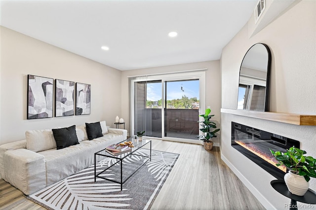 4274 S Salida Way Unit 3, Aurora, CO 80013 - living room featuring wood finished floors, recessed lighting, baseboards, and a glass covered fireplace