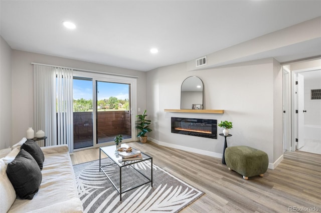 4274 S Salida Way Unit 3, Aurora, CO 80013 - living room with a glass covered fireplace, wood finished floors, baseboards, and recessed lighting