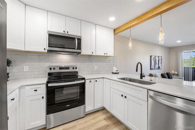 4274 S Salida Way Unit 3, Aurora, CO 80013 - kitchen featuring stainless steel appliances, a sink, decorative backsplash, white cabinetry, and recessed lighting