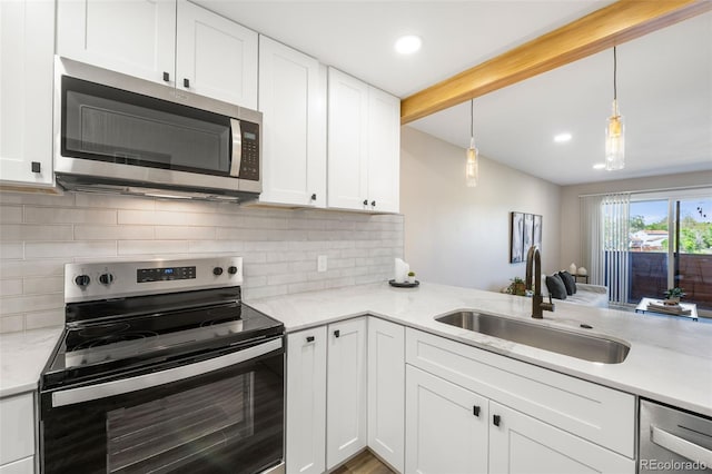 4274 S Salida Way Unit 3, Aurora, CO 80013 - kitchen featuring appliances with stainless steel finishes, a sink, white cabinets, tasteful backsplash, and recessed lighting