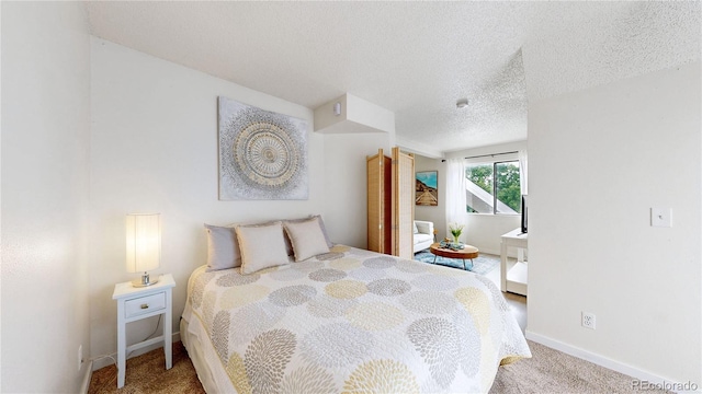 8701 Huron St Unit 1-207, Thornton, CO 80260 - bedroom with carpet floors, baseboards, and a textured ceiling